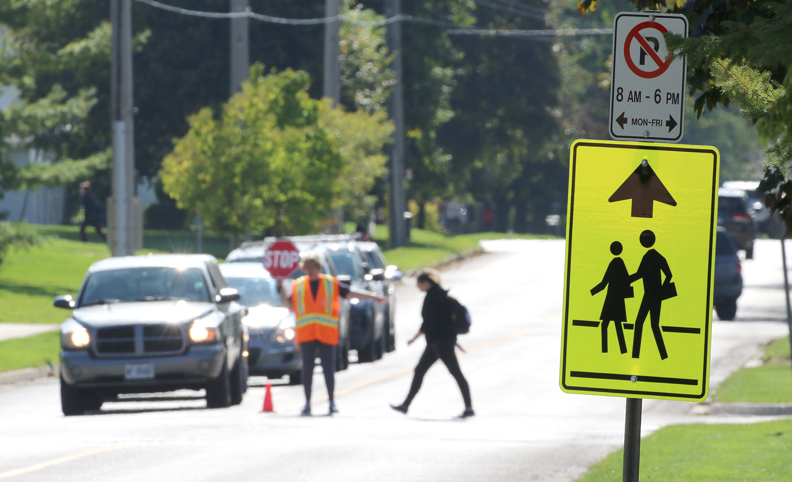 School Travel Safety Photo of school crossing guard with student